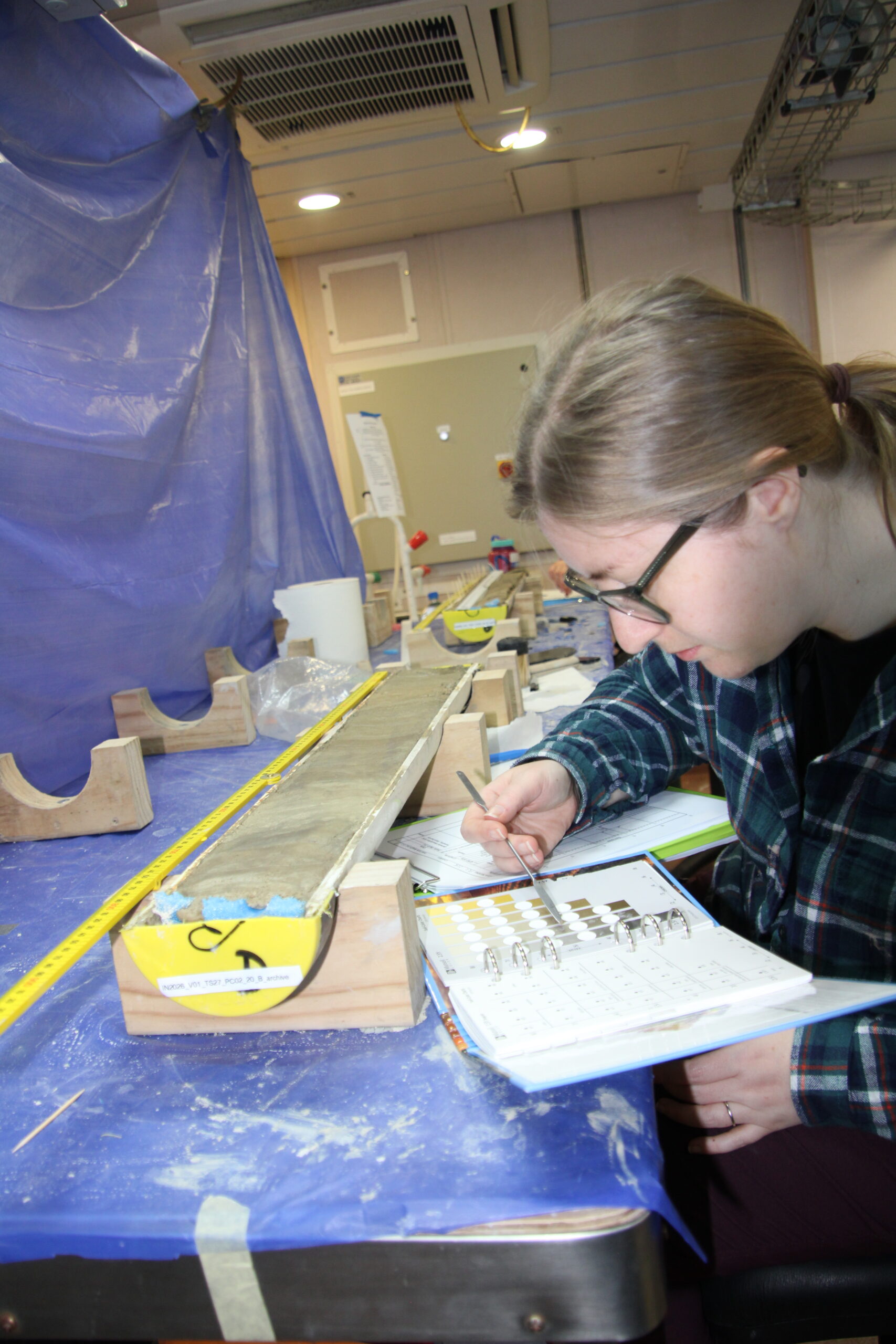 Rebecca Knight (University of Exeter, England) colour matching a segment of the core. Image credit: J. Lalime.