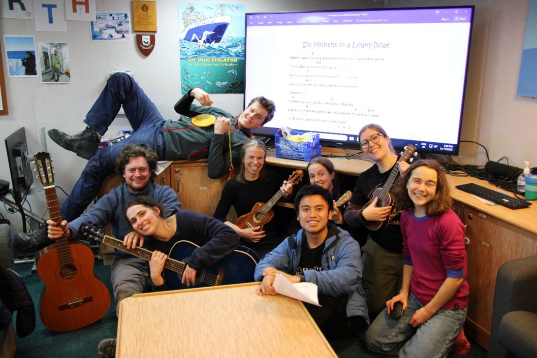 Cores with Chords – making the most of our downtime by playing our favourite nautical songs together. L-R Luca Magri, Lucinda Duxbury; Noah Menner; Jan Strugnell; Timothy Nugroho; Sarah Jessop; Rebecca Knight; Izzy White. Image credit: Joline Lalime.