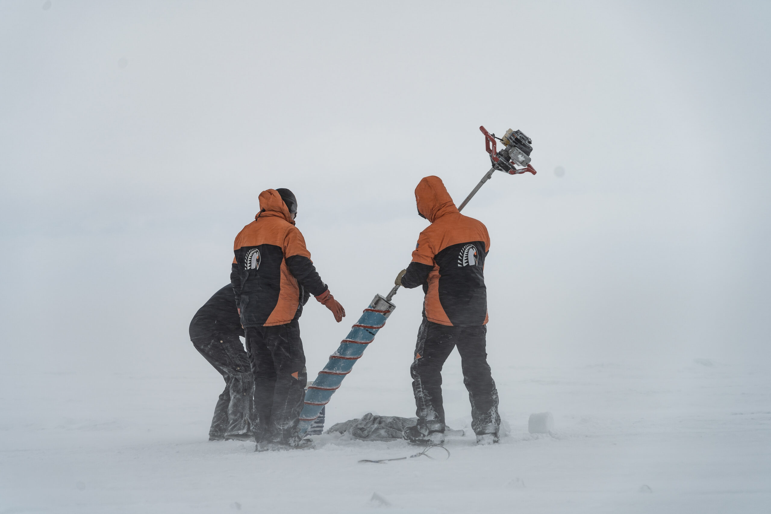 A team of researchers extract a sea ice core to measure sea ice properties. While the surface looks hostile and devoid of life, below them the seafloor is extremely biodiverse. Credit: Emiliano Cimoli IMAS