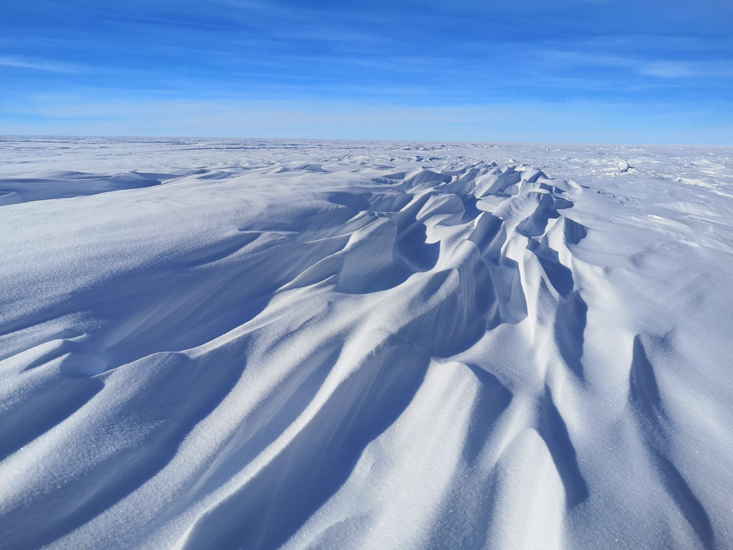 Wind-sculpted snow on Antarctic ice sheet. Credit: Andy Hung / AAD
